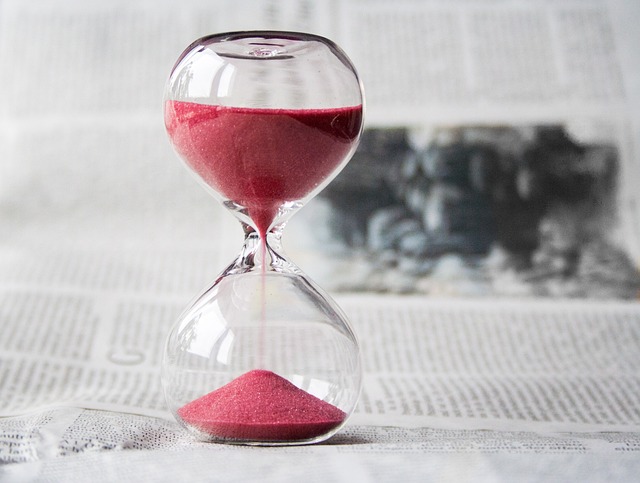 a hourglass on a newspaper